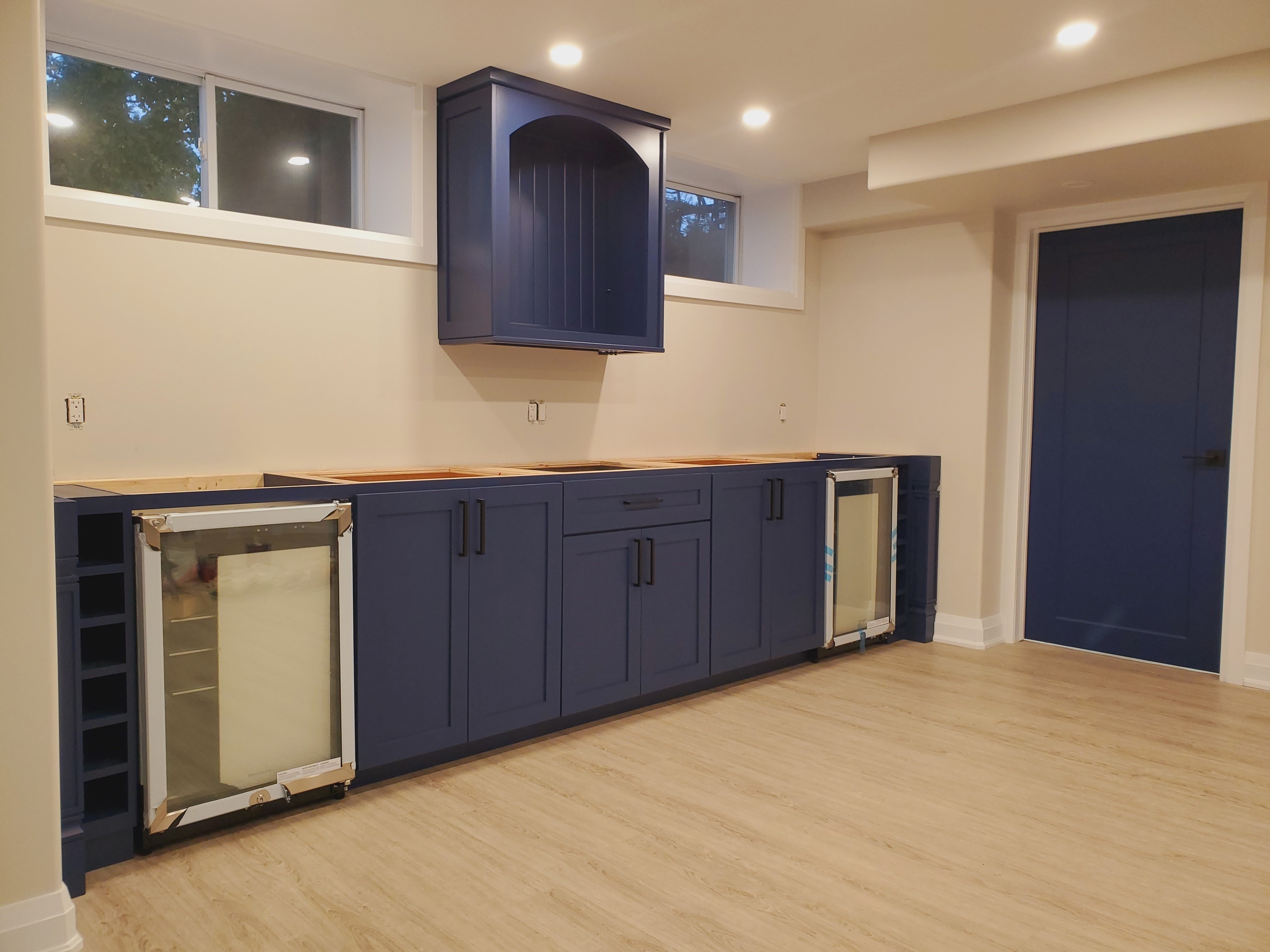 basement bar with blue maple painted doors 