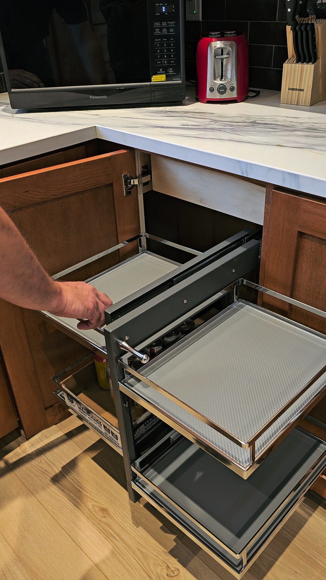 Magic Corner is a specialized soft-close pull-out storage system designed to maximize space and accessibility by Cedar Lane Custom Kitchens