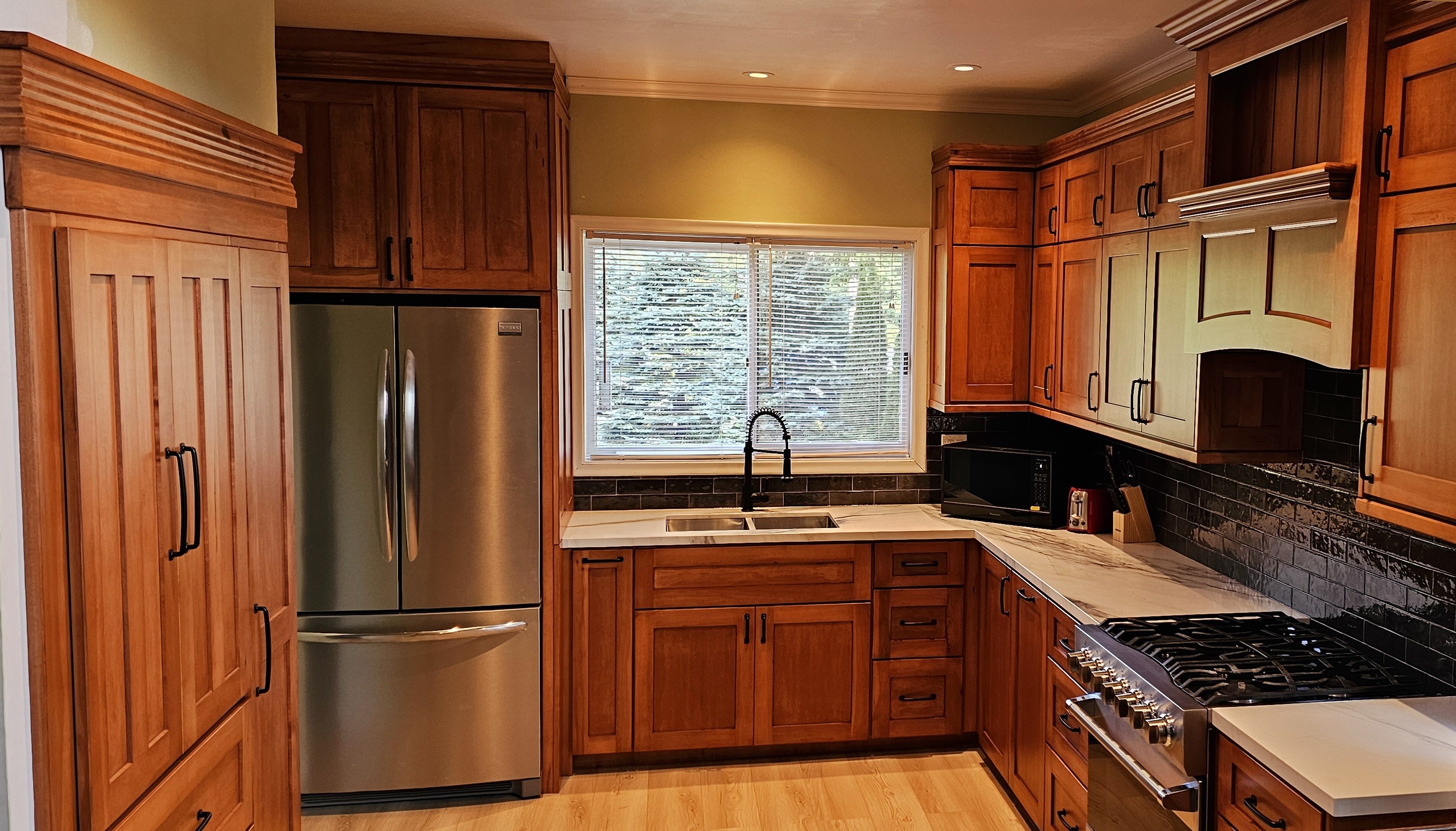 Maple kitchen cabinets with pantry and custom range hood  by cedar lane custom kitchens in Waterford Ontario