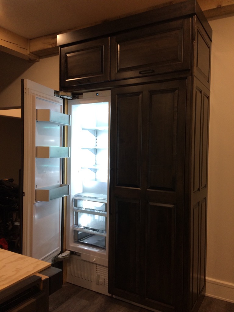 built in sub-zero fridge and freezer cabinet with top storage