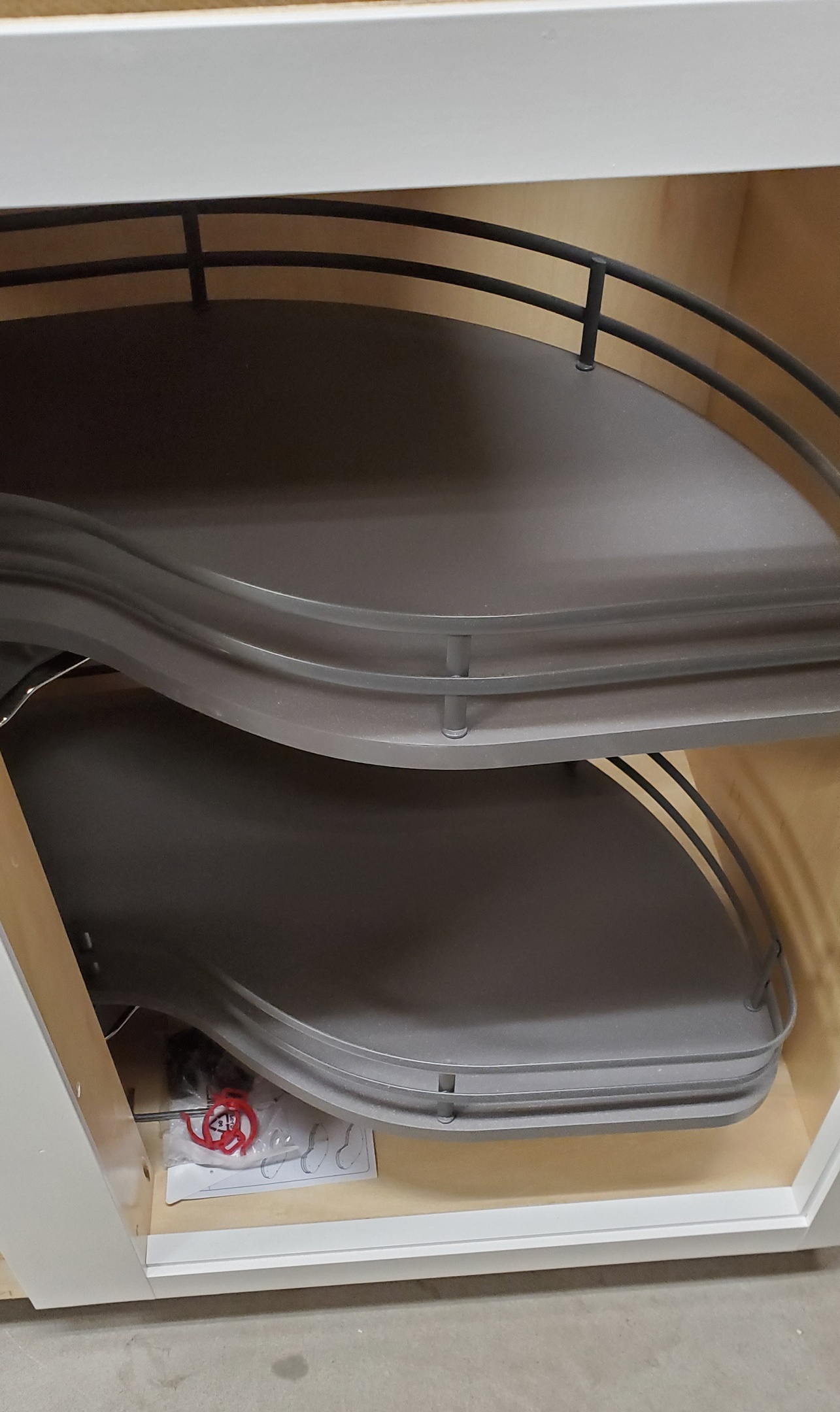 A soft-close kidney pull-out drawer (often referred to as a kidney-shaped Lazy Susan or swing-out unit) is a specialized storage solution designed to maximize space. Cedar Lane Custom Kitchens.