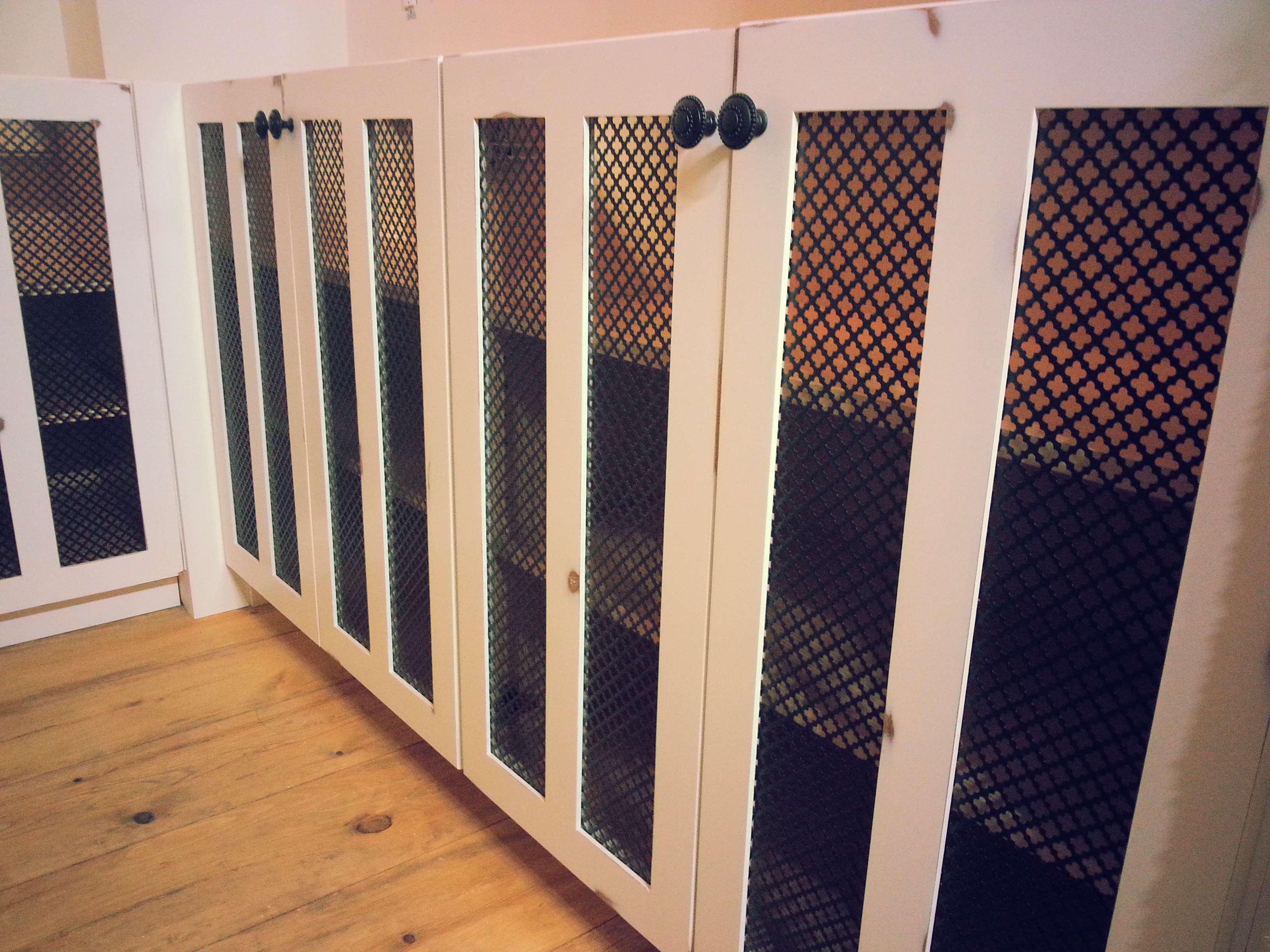 white distressed cabinet with metal mesh design